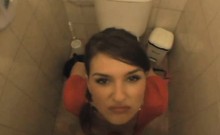 Brunette Taking Facial Cumshot In Public Bathroom Stall